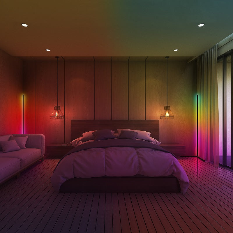 Modern bedroom with wooden floor, bed, and colorful wall lighting